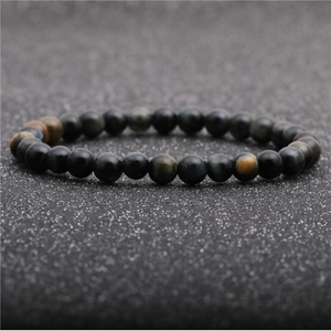 Macro shot of 8mm blue tiger's eye beaded bracelet with golden silk sheen and cat's eye effect