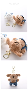 Detail of plush dog keychains wearing denim overalls with fine wood buttons