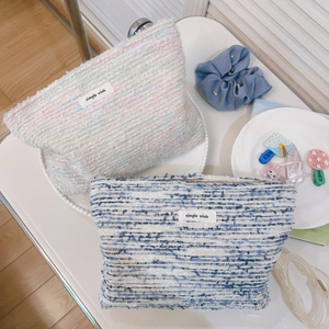 Tweed cosmetic bags in pink-blue and white-blue weave with zip closure and logo detail