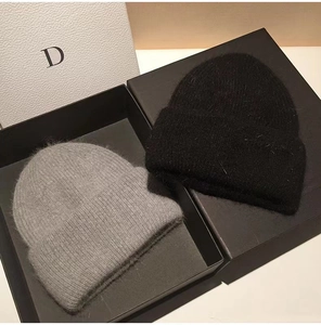 Detailed macro view of fluffy knit mohair beanie hats in black and grey colors