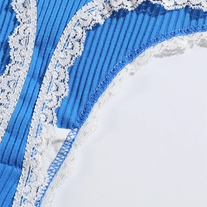 Detailed close-up of blue ribbed cotton thong with delicate white lace edge trim