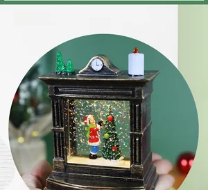 Close-up of vintage fireplace snow globe featuring a girl decorating a Christmas tree