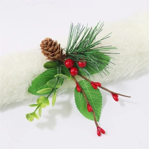 Detailed view of Christmas napkin ring featuring red berries, pine needles and natural cones
