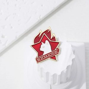 Red star flame cat enamel pin with Soviet style lettering on white pedestal