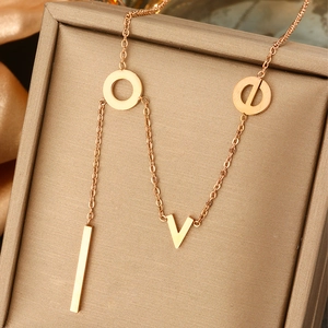 Detail of rose gold LOVE letter pendant necklace resting on a premium jewelry box