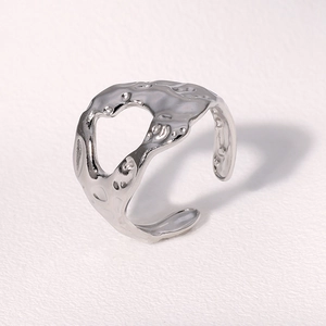 Macro detail of silver adjustable ring with irregular molten lava metal texture