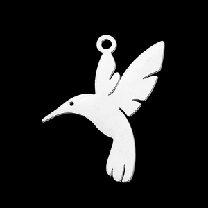 Close-up of polished silver hummingbird pendant made of stainless steel for DIY jewelry