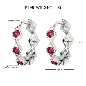 Macro detail of F899 brass earrings with AAA+ ruby zircons and wave texture