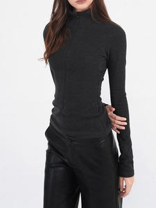 Detailed close-up of dark grey slim-fit knit sweater with quarter-zip turtleneck design