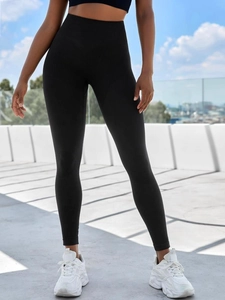 Close-up of high-waisted seamless yoga leggings with peach-lift stitching in black