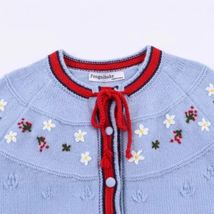Blue knit cardigan with floral embroidery and red striped trim details