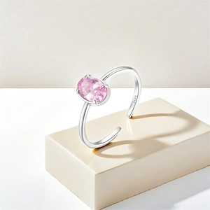 Detail of adjustable S925 silver ring featuring an oval pink zircon in a four-prong setting