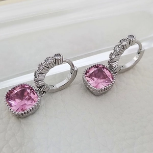 Macro shot of silver studs with a square pink zircon and white diamond accents