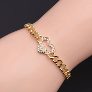 Adjustable gold double heart bracelet with cubic zirconia on a model's wrist