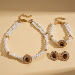 Macro detail of vintage baroque pearl necklace set with tiger eye stones and gold accents