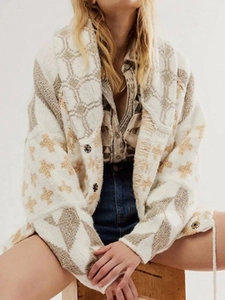 Detail of Y2K knit cardigan showing brown geometric jacquard pattern and vintage buttons