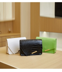 Three elegant small crossbody chain bags with stone texture in white, black and green