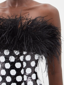 Detail of white sequined polka dots and luxurious black ostrich feather trim on top