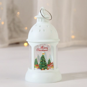 Close-up of a white Christmas lantern with a metal ring and festive Merry Christmas print