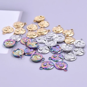 Detailed view of round angel pendants in gold, silver and rainbow stainless steel finishes