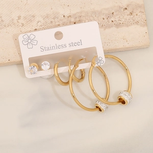 Three-pair stainless steel earring set featuring rhinestone studs and gold hoop earrings