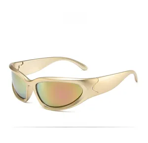 Detail view of Y2K steampunk cycling sunglasses with matte gold frame and red gradient lenses