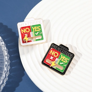 Macro shot of sliding metal enamel pins showing Yes No options and My Attitude text