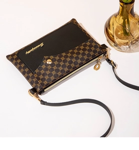 Detail of vintage crossbody bag with circle patterns and black leather patchwork