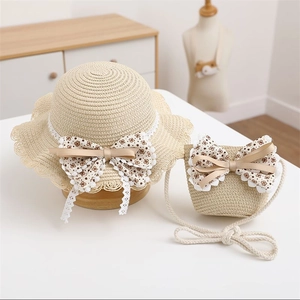 Detailed texture of beige straw sun hat and matching crossbody bag with lace trim