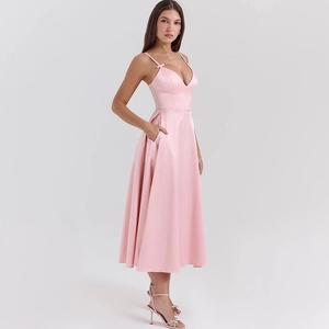 Detail of pink satin V-neck dress featuring delicate straps and functional side pockets