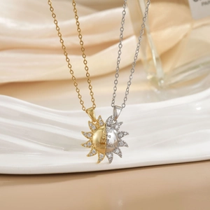 Macro detail of sun-shaped puzzle necklaces with You Are MY Sunshine engraving and cubic zirconia
