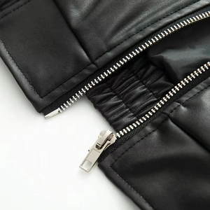 Detail of premium black faux leather texture with high-quality metal zipper and stitching