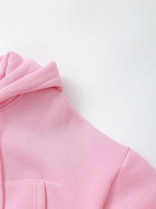 Detail of pink hoodie neckline and hood stitching with visible fabric texture