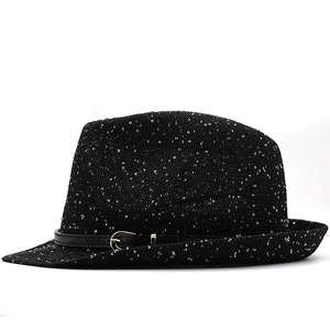 Detail of black sequin fedora hat featuring a leather strap and gold metal buckle