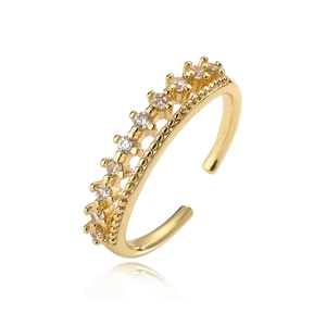 Gold plated adjustable ring with sparkling cubic zirconia on a white background