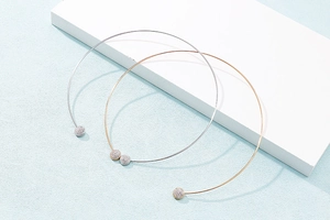 Detail of minimalist gold and silver stainless steel rings with round crystal inlay