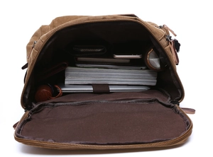 Interior layout of brown canvas backpack showing large capacity for laptop and books