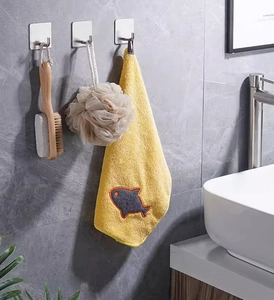 Three brushed stainless steel adhesive wall hooks installed on grey marble bathroom tile