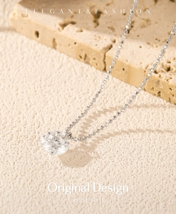 Macro view of S925 silver round cut moissanite pendant on elegant bead chain