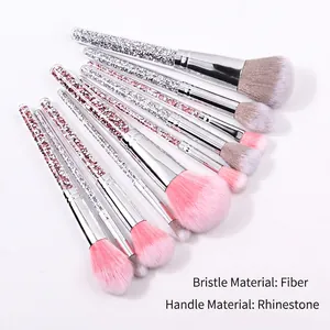Set of 10 pink diamond handle makeup brushes with soft fiber bristles on white background