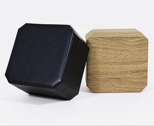 Close-up of octagonal watch boxes in black leather and light wood grain finishes