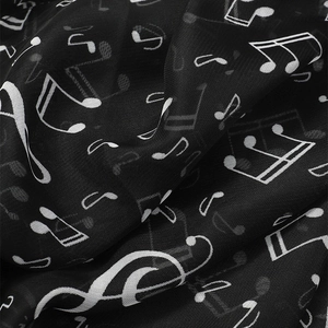 Macro detail of lightweight chiffon scarf with elegant white musical note prints