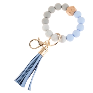 Close-up of silicone beads with marble texture, wood bead, and blue leather tassel detail