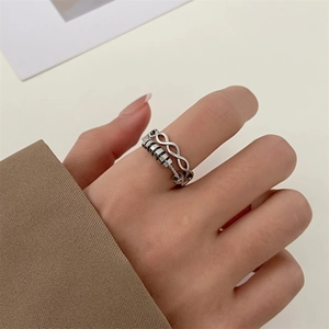 Detailed view of a silver double-layered spinning ring with beads on a model's hand