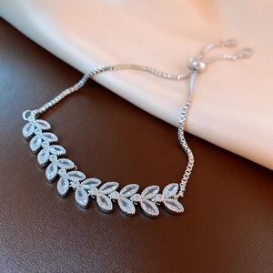 Detail of silver leaf bracelet with zircon stones and adjustable sliding clasp closure