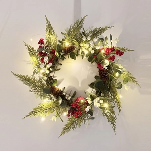 Christmas wreath with LED lights, pine cones, red berries and eucalyptus leaves decor