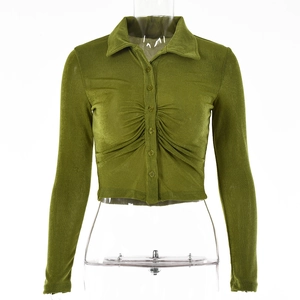 Detail of olive green cropped shirt featuring pleated chest design and button closure