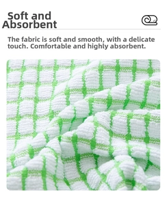 Close-up of green checkered cotton tea towel featuring a soft honeycomb texture