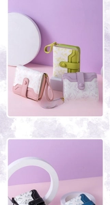 Detailed view of floral women's short wallets with wrist straps in multiple pastel colors