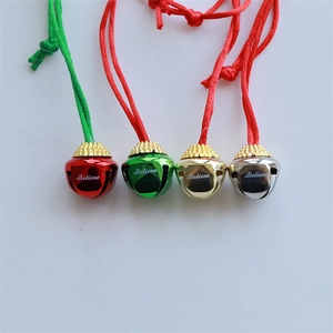 Set of four colorful Christmas metal bells in red green gold and silver with Believe print